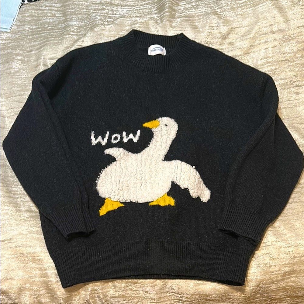 Playful Black and Cream Sweater with Wow Duck